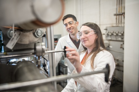 Two students working with a compressor